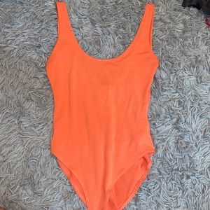 Pinkish orange body suit